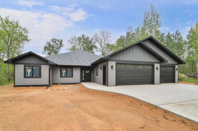 16 Deblock Ln, Crosby, MN 56441 - view of front of home featuring driveway, an attached garage, board and batten siding, and roof with shingles