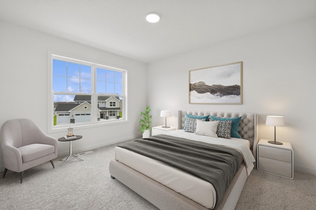 carpeted bedroom featuring baseboards and visible vents