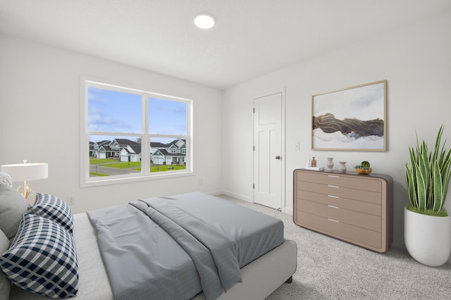 bedroom with baseboards and light colored carpet