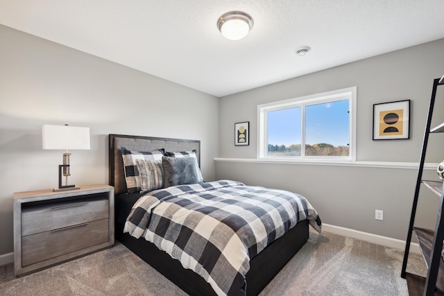 carpeted bedroom featuring baseboards