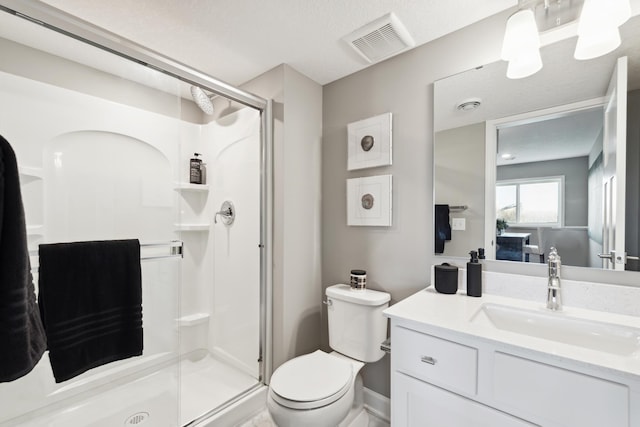 full bathroom featuring visible vents, a shower stall, vanity, baseboards, and toilet
