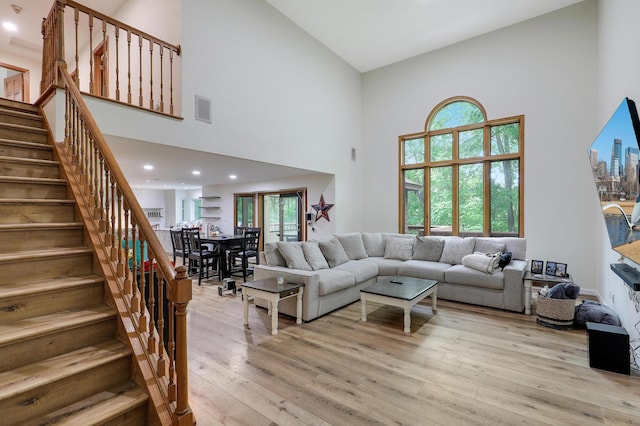 655 Trails End Rd, Minnetrista, MN 55364 - living room featuring high vaulted ceiling, light wood finished floors, stairway, healthy amount of natural light, and recessed lighting