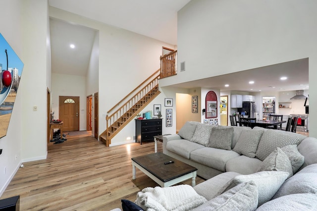 655 Trails End Rd, Minnetrista, MN 55364 - living area featuring a high ceiling, light wood-type flooring, stairs, baseboards, and recessed lighting