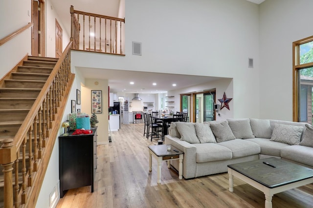 655 Trails End Rd, Minnetrista, MN 55364 - living area featuring a high ceiling, light wood finished floors, and stairway