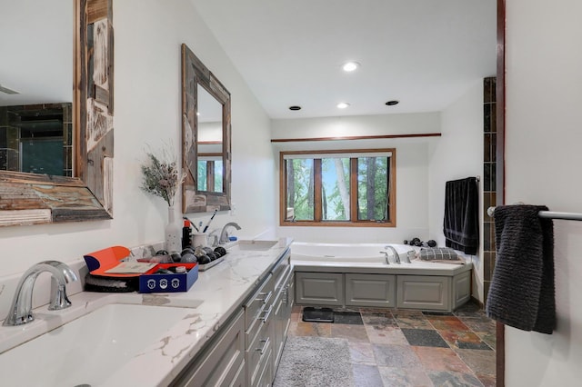 655 Trails End Rd, Minnetrista, MN 55364 - full bathroom featuring double vanity, a garden tub, stone finish floors, and recessed lighting