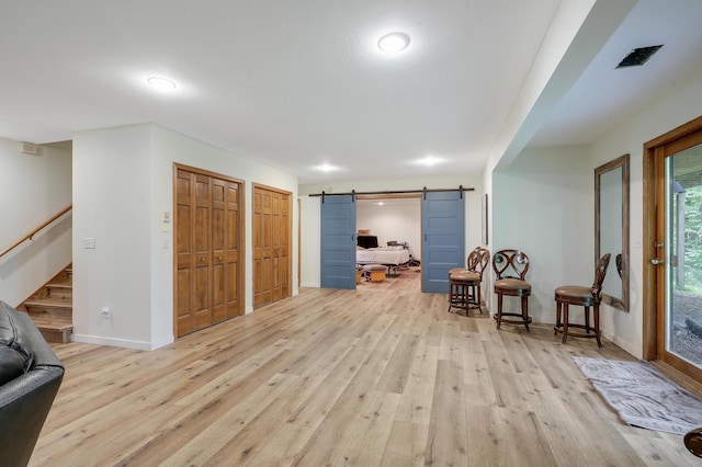 655 Trails End Rd, Minnetrista, MN 55364 - sitting room with light wood-style floors, a barn door, baseboards, and stairway