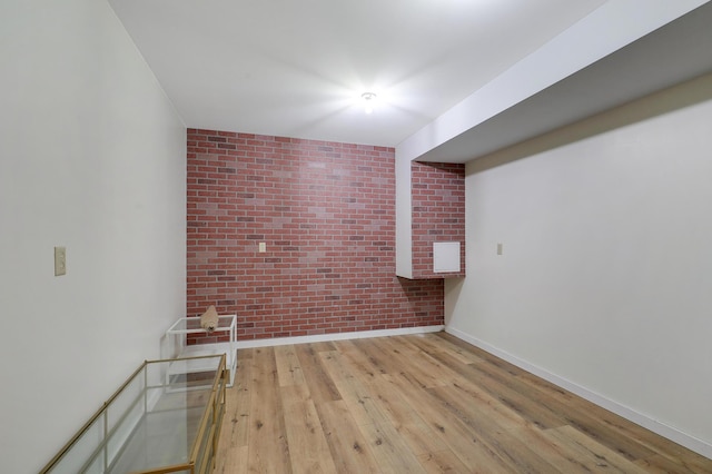 655 Trails End Rd, Minnetrista, MN 55364 - spare room featuring brick wall, wood-type flooring, and baseboards
