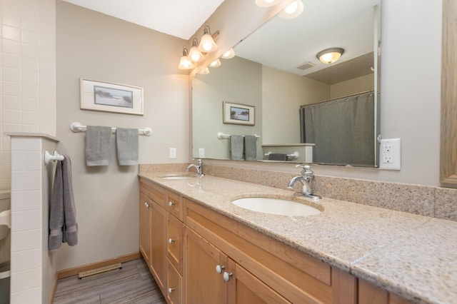 3008 Highland Blvd, Mound, MN 55364 - full bathroom featuring double vanity, wood finished floors, baseboards, and a shower with shower curtain