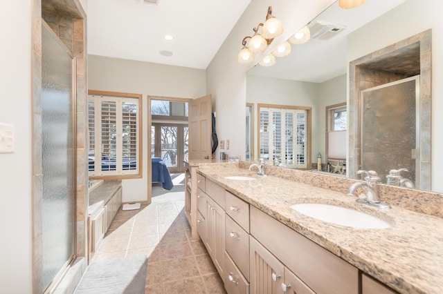 3008 Highland Blvd, Mound, MN 55364 - ensuite bathroom with tile patterned floors, double vanity, plenty of natural light, a stall shower, and recessed lighting