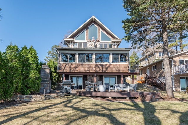 3008 Highland Blvd, Mound, MN 55364 - rear view of house with a balcony, a lawn, a deck, and stairway