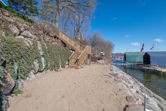 3008 Highland Blvd, Mound, MN 55364 - view of yard featuring a dock, a water view, stairs, and boat lift