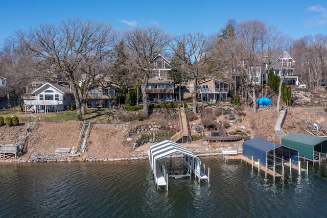 3008 Highland Blvd, Mound, MN 55364 - dock with boat lift, a water view, stairs, and a residential view