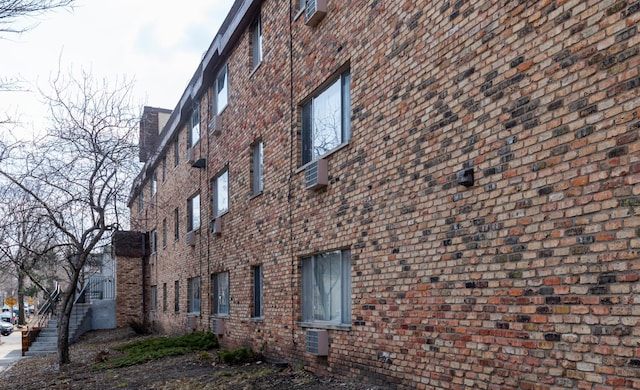 view of home's exterior featuring brick siding and a chimney