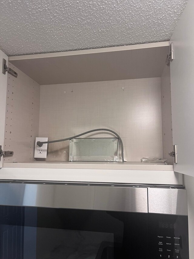 2446 Aldrich Ave S Unit 111, Minneapolis, MN 55405 - kitchen view of a textured ceiling, backsplash, and wall oven
