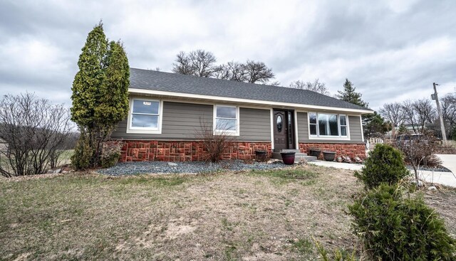 32955 County 24th Blvd, Cannon Falls, MN 55009 - ranch-style home featuring a shingled roof, entry steps, stone siding, and a front lawn