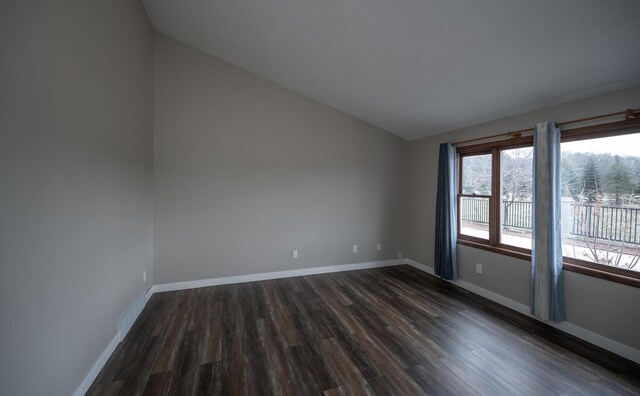32955 County 24th Blvd, Cannon Falls, MN 55009 - unfurnished room featuring dark wood-style floors, baseboards, and vaulted ceiling