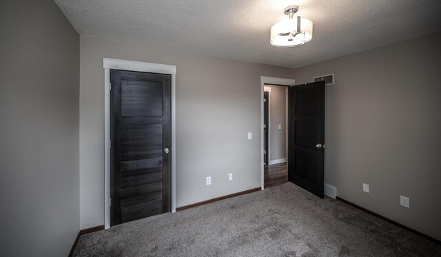 32955 County 24th Blvd, Cannon Falls, MN 55009 - unfurnished bedroom featuring visible vents, baseboards, carpet flooring, and a textured ceiling