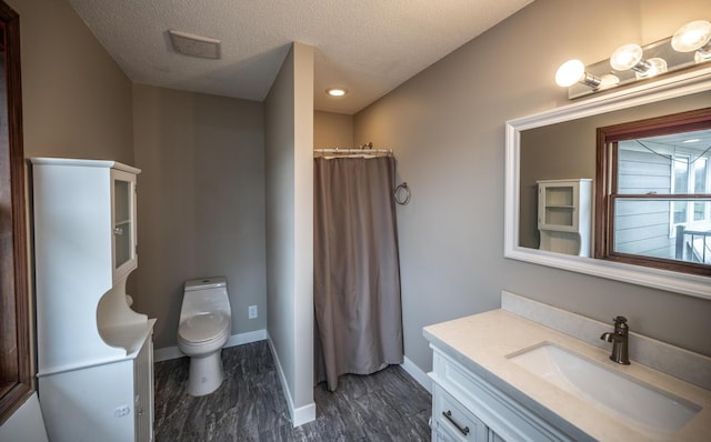 32955 County 24th Blvd, Cannon Falls, MN 55009 - full bathroom featuring toilet, a textured ceiling, vanity, and baseboards