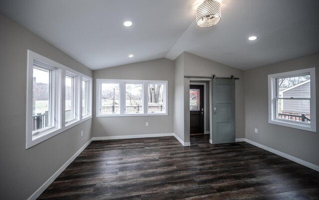 32955 County 24th Blvd, Cannon Falls, MN 55009 - unfurnished bedroom featuring baseboards, recessed lighting, dark wood-type flooring, a barn door, and lofted ceiling
