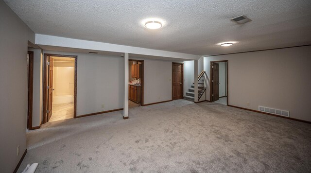 32955 County 24th Blvd, Cannon Falls, MN 55009 - finished basement featuring light carpet, a textured ceiling, visible vents, and stairway
