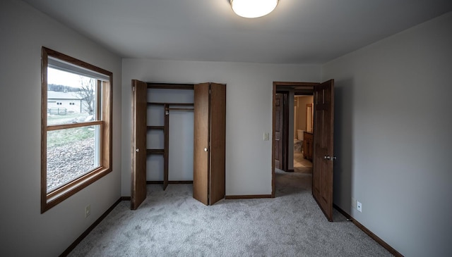 32955 County 24th Blvd, Cannon Falls, MN 55009 - unfurnished bedroom featuring light carpet, multiple windows, baseboards, and a closet
