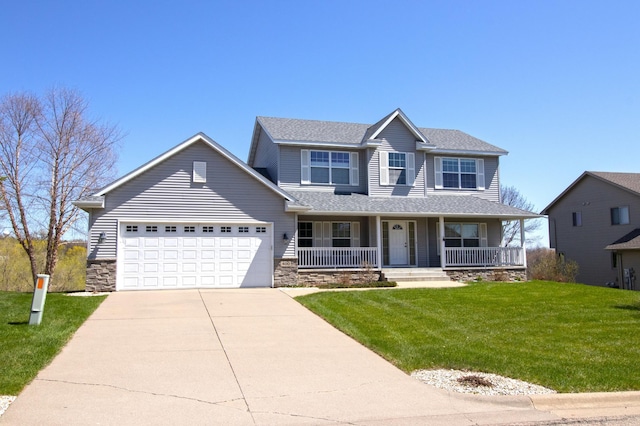 view of front of property with a front lawn, covered porch, driveway, stone siding, and an attached garage