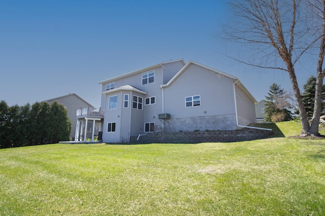 rear view of house featuring a yard