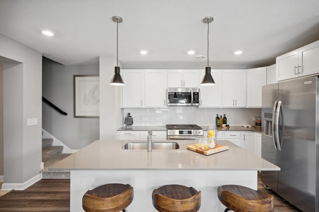 1083 151st St W, Rosemount, MN 55068 - kitchen featuring stainless steel appliances, a sink, dark wood-style floors, backsplash, and recessed lighting