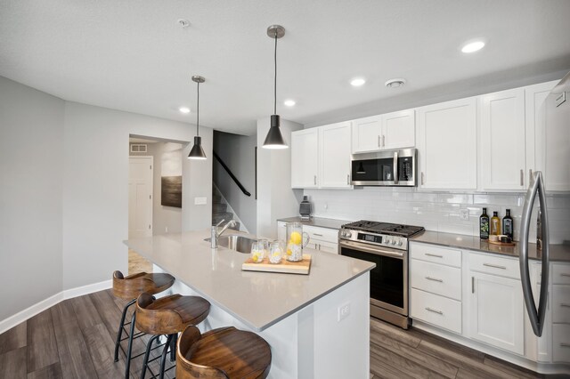 1083 151st St W, Rosemount, MN 55068 - kitchen featuring appliances with stainless steel finishes, a sink, dark wood-type flooring, backsplash, and recessed lighting