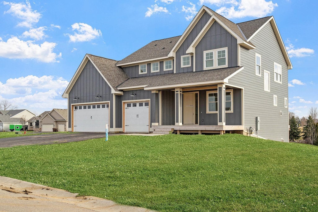 craftsman inspired home featuring driveway, board and batten siding, and a shingled roof