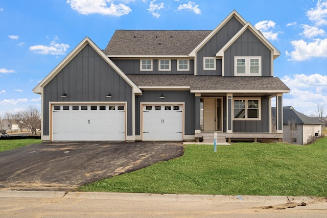 view of front of house featuring board and batten siding, a shingled roof, aphalt driveway, and a front yard