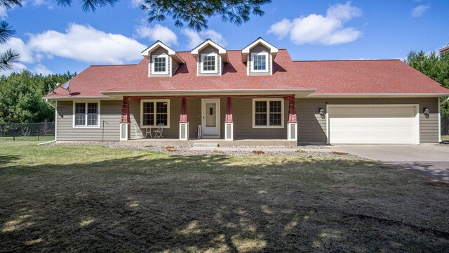 cape cod-style house with a garage, covered porch, fence, a front lawn, and driveway