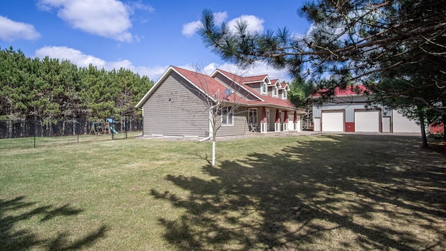 exterior space featuring an outdoor structure, fence, a playground, a front lawn, and a garage