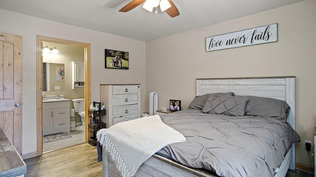 bedroom featuring light wood finished floors, connected bathroom, and ceiling fan