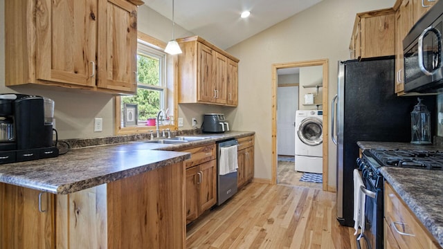 kitchen featuring washer / clothes dryer, dishwasher, a sink, dark countertops, and lofted ceiling