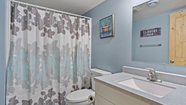 bathroom with vanity, a shower with curtain, and toilet