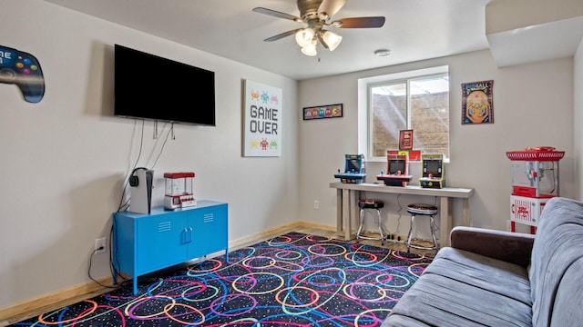 interior space featuring baseboards and a ceiling fan