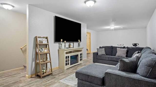 living room featuring light wood-style flooring and baseboards
