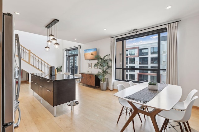 3104 Lake St Unit 410, Minneapolis, MN 55416 - kitchen featuring dark brown cabinetry, light wood-type flooring, hanging light fixtures, freestanding refrigerator, and recessed lighting
