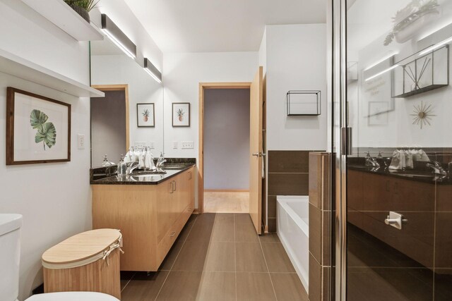 3104 Lake St Unit 410, Minneapolis, MN 55416 - bathroom with double vanity, a bath, and tile patterned floors