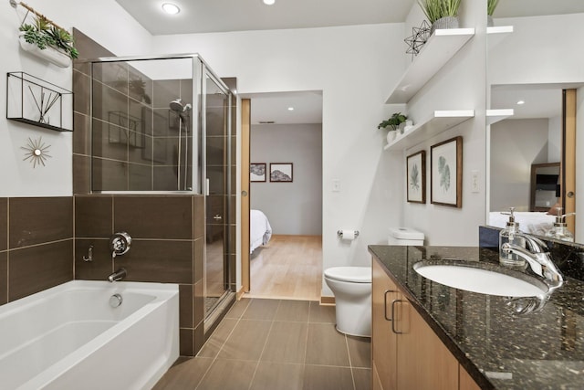 3104 Lake St Unit 410, Minneapolis, MN 55416 - ensuite bathroom with vanity, a bath, a stall shower, recessed lighting, and tile patterned floors