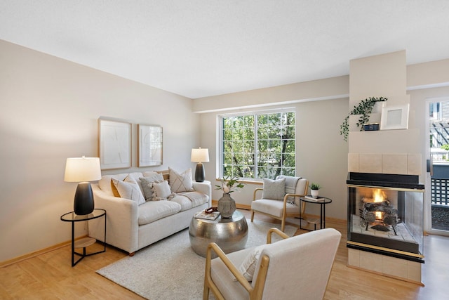 15625 24th Ave N Unit G, Plymouth, MN 55447 - living area featuring wood finished floors, plenty of natural light, and a tile fireplace