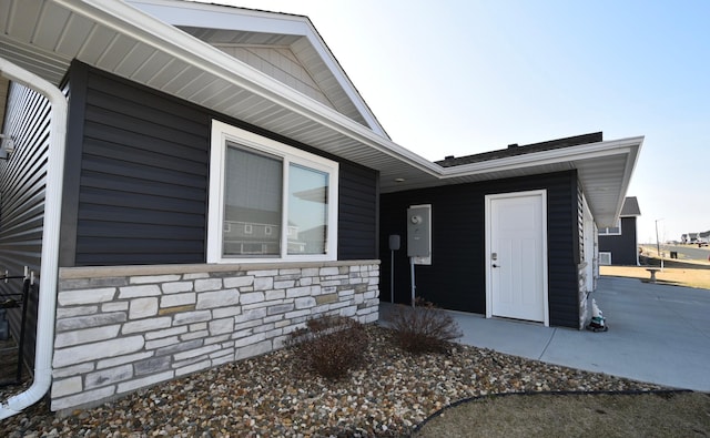 doorway to property featuring stone siding