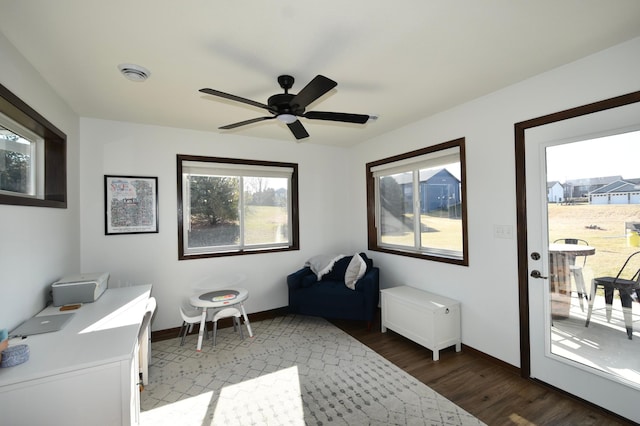 office area with baseboards, a ceiling fan, and dark wood-style floors