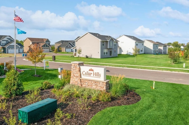 community sign with a yard and a residential view