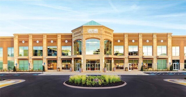 view of building exterior featuring uncovered parking