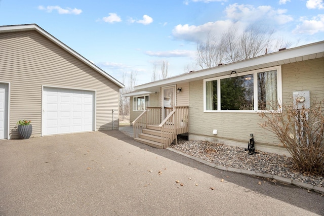 ranch-style home featuring a garage and driveway