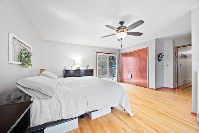 bedroom featuring visible vents, wood finished floors, access to exterior, baseboards, and ceiling fan