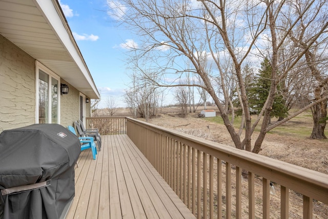 wooden terrace featuring grilling area