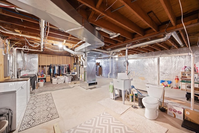 unfinished basement featuring heating unit and water heater